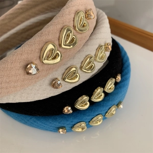 Detail of retro padded velvet headbands with golden metal hearts and crystal rhinestones