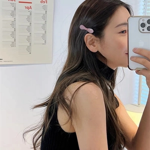 Pink acetate bow hair clip styled on hair for a minimalist and elegant Korean aesthetic