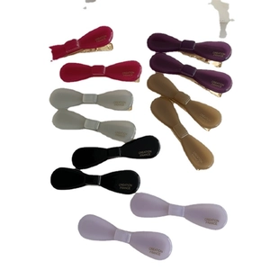 Set of colorful acetate bow hair clips with Creation France text on a white background