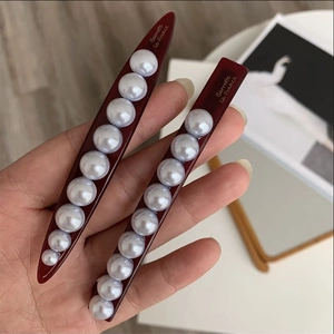 Elegant burgundy red barrette with white pearls and Barrette la France script lettering