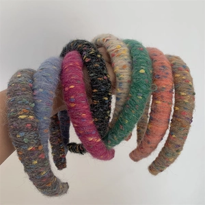 Detail shot of multi-colored knitted headbands showing thick wool texture and fluffy yarn