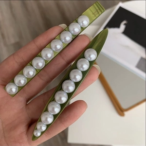 Elegant green acetate hair claw clips set with white pearls for women in retro style