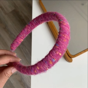 Detail showing the soft pink knitted mohair texture with colorful speckles on this headband