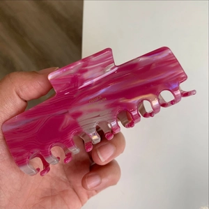 Close-up of pink marble pattern hair claw clip with gold France Handmade logo
