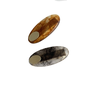 Minimalist marble resin oval hair clips with gold metal detail in amber and grey