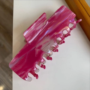 Detail view of pink marble textured hair claw clip with gold FRANCE Handmade lettering