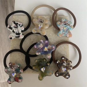 Detailed view of colorful bear-shaped hair ties with rhinestones and elastic bands
