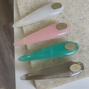 Set of four acrylic waterdrop hair clips in marble white, pink, green, and amber colors