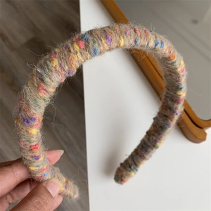 Close-up of rainbow knitted wool wrapped headband with colorful texture details