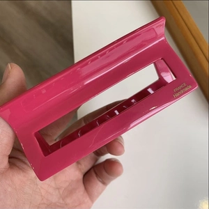 Close-up of bright pink rectangular hair claw clip with gold France Handmade text