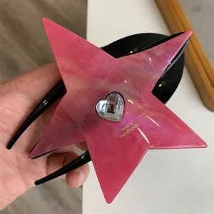 Detail of pink marble star hair claw clip with heart rhinestone and handmade engraving