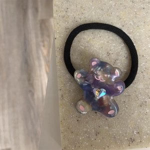 Close-up of cute blue-purple gradient bear charm with heart rhinestone on elastic hair tie