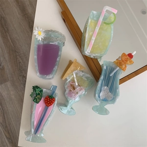 Detail of five creative cocktail-shaped cellulose acetate hair claws on a white surface