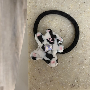 Cute cartoon bear hair tie with cow patterns and a heart-shaped rhinestone