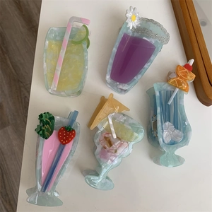 Detail of 5 acetate cocktail-shaped hair claws with decorative fruit slices and straws