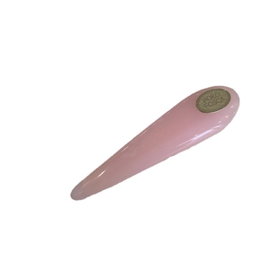 Elegant pink teardrop acrylic hair clip with gold metal brand logo and polished finish