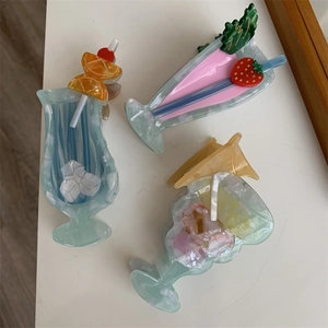Close-up of acetic acid hair claw clip in summer cocktail drink shape with strawberry decor