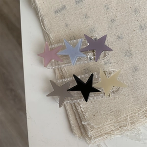 Close-up of Morandi star hair clips set on linen fabric background for women