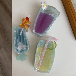 Close-up of creative acetate hair claws shaped like cocktail drinks and summer beverages