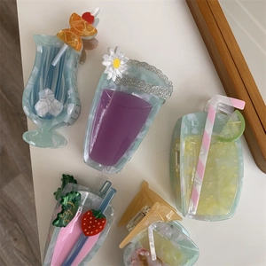 Detail of unique summer cocktail and juice shaped hair claws with 3D fruit decorations