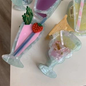 Detail view of cocktail-shaped acetate hair claw clips with colorful summer drink patterns