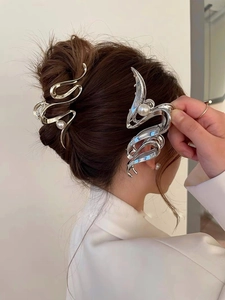 Detail view of liquid metal hair clips with pearls worn by a model in a side profile