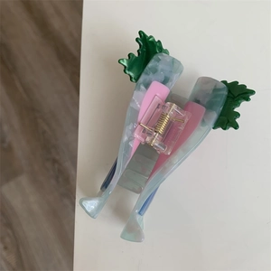 Macro view of a cute marble acetate hair claw clip featuring a creative radish vegetable shape