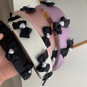 Elegant bow headband with heart pearl detail in black white pink and purple colors