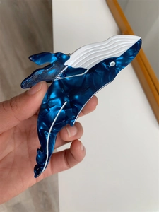 Detailed view of the creative blue whale hair claw clip made of acetate with marble texture