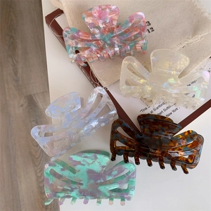 Pink and multicolored acetate shark hair clips in five assorted marbled patterns