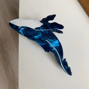 Macro detail of whale hair claw clip showing blue marble acetate material and texture
