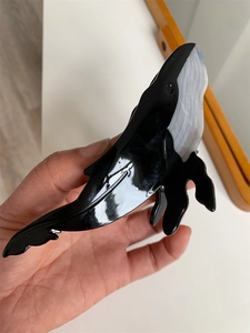 Detail of creative blue whale acetate hair claw clip showing color block design