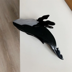 Detail shot of blue whale hair claw clip with black and white marble acetate finish