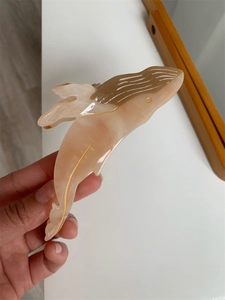 Macro detail of whale hair claw clip showing marble pattern acetate texture and golden lines