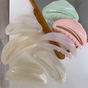 Close-up of crescent acetate hair claws with glossy finish and France Handmade lettering