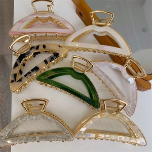 Elegant gold metal arched hair claw clips with colorful acetate marble patterns