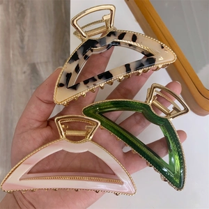 Minimalist geometric claw clips in acetate tortoise and emerald green with gold alloy frames