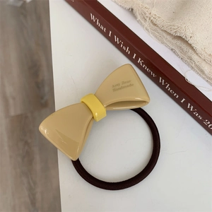 Detail of Amy Bear Handmade bow hair tie with high-elastic rope and beige acrylic finish