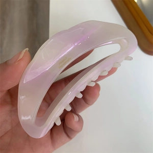 Detailed close-up of crescent hair claw showing pearlescent acetate and France Handmade text