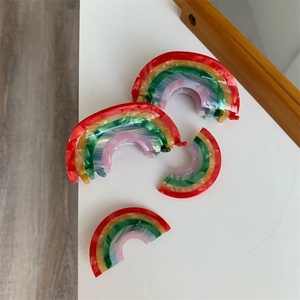 Set of four creative rainbow acetate hair claws with marble texture for styling