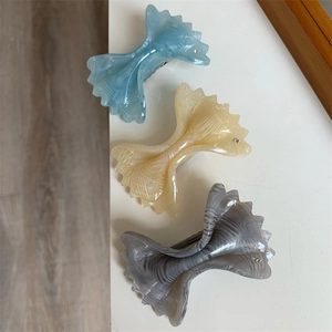 Three-piece set of elegant marble acetate bow hair clips in blue, beige, and purple