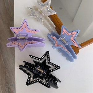 Star-shaped acetate hair claws with sparkling rhinestones in four elegant colors