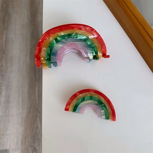 Detail view of rainbow marble texture acetate hair claw clip and duckbill side pin set