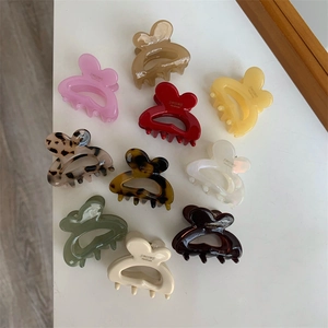 Close-up of heart-shaped acetate hair clips in various colors with handmade text