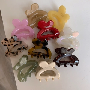 Detail view of 10 colorful bunny ear hair clips with golden SAN SHINE handmade text