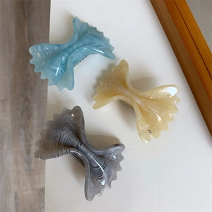 Three acetate bow hair clips in light blue, beige and taupe with rhinestones