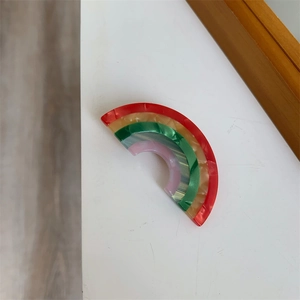 Detailed macro view of the rainbow acetate hair clip with marble texture and vivid colors