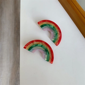 Detailed macro view of rainbow acetate hair clip with colorful marble pattern texture