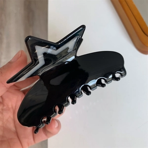 Chic black acetate star claw clip with rhinestone details for high-end hairstyling