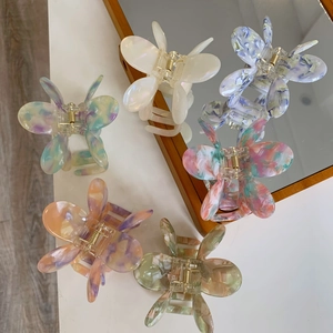 Set of six butterfly acetate hair claws in various marble textures and pearlescent colors